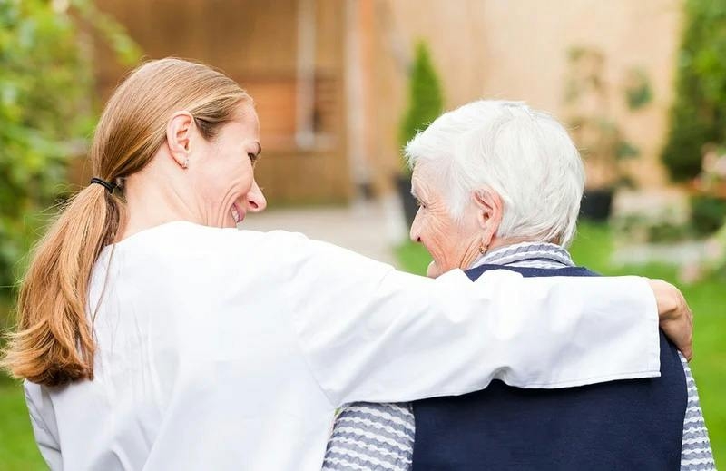 A nurse looks after an elderly woman